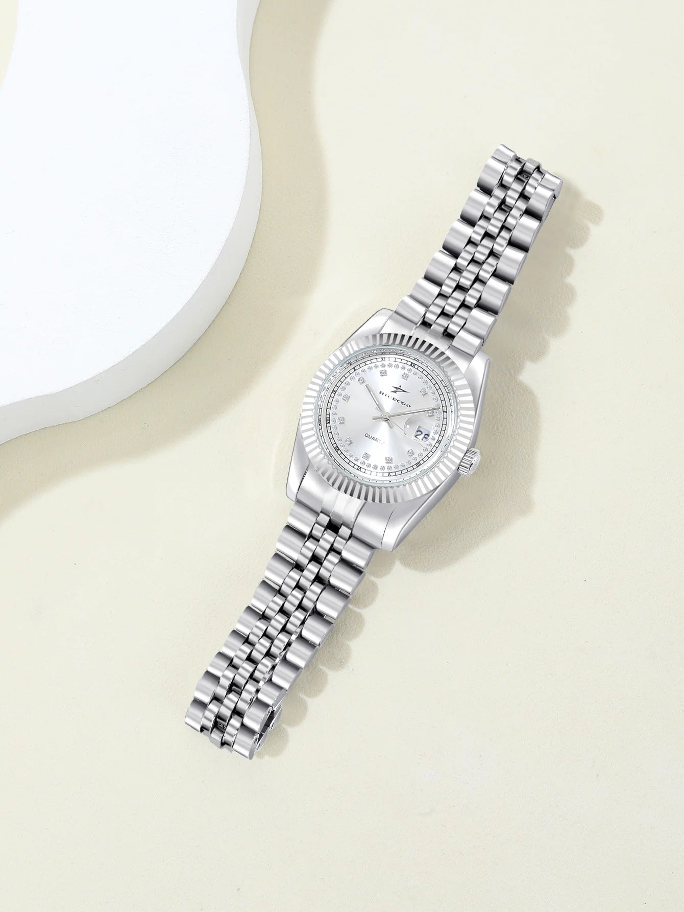 A women's quartz wristwatch with a textured bezel design and diamond studded dial decoration, equipped with date display functio